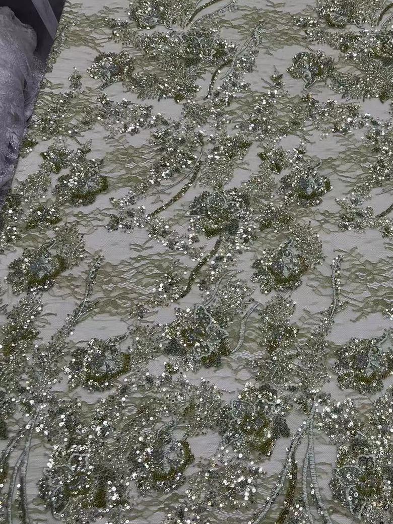 Machine-embroidered sequin lace in sage green