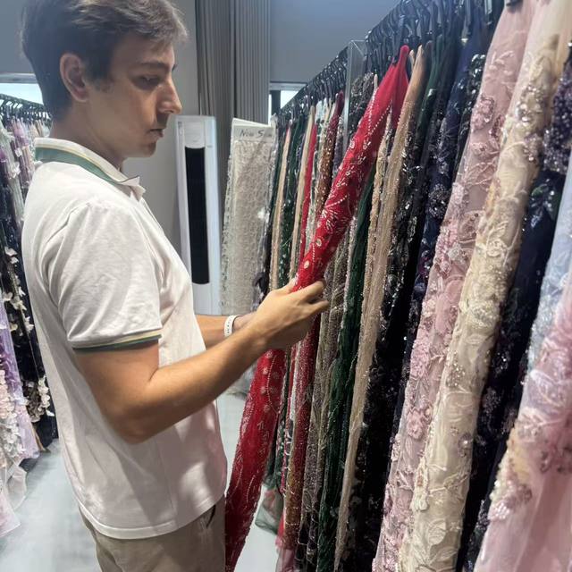 Selecting beaded lace qualities at a supplier showroom
